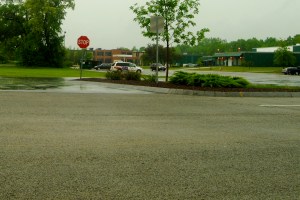 You can't tell, but it's raining hard outside Watson's window. The porous pavement near the camera looks dry but the non-porous pavement in the distance is all puddles.
