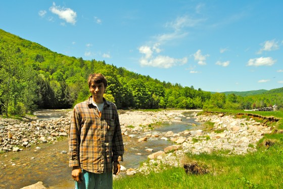 Ryan Wood Beauchamp stands by the river that now runs through his farm.