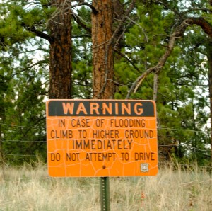 Signs warn of flood risk near the Hayman burn scar.