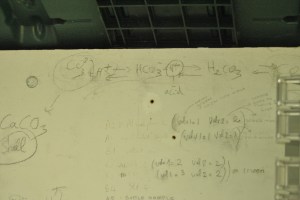 The carbonate cycle was written on a white board next to monitoring equipment at Taylor Shellfish's hatchery